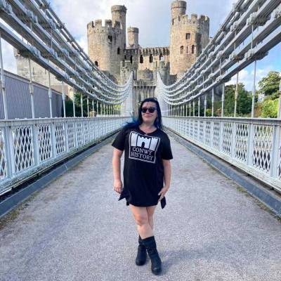 Coleg Llandrillo lecturer Morgan Ditchburn on the Conwy suspension bridge in front of Conwy Castle