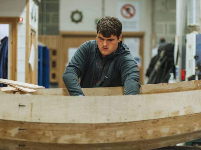 Learner fixing a boat